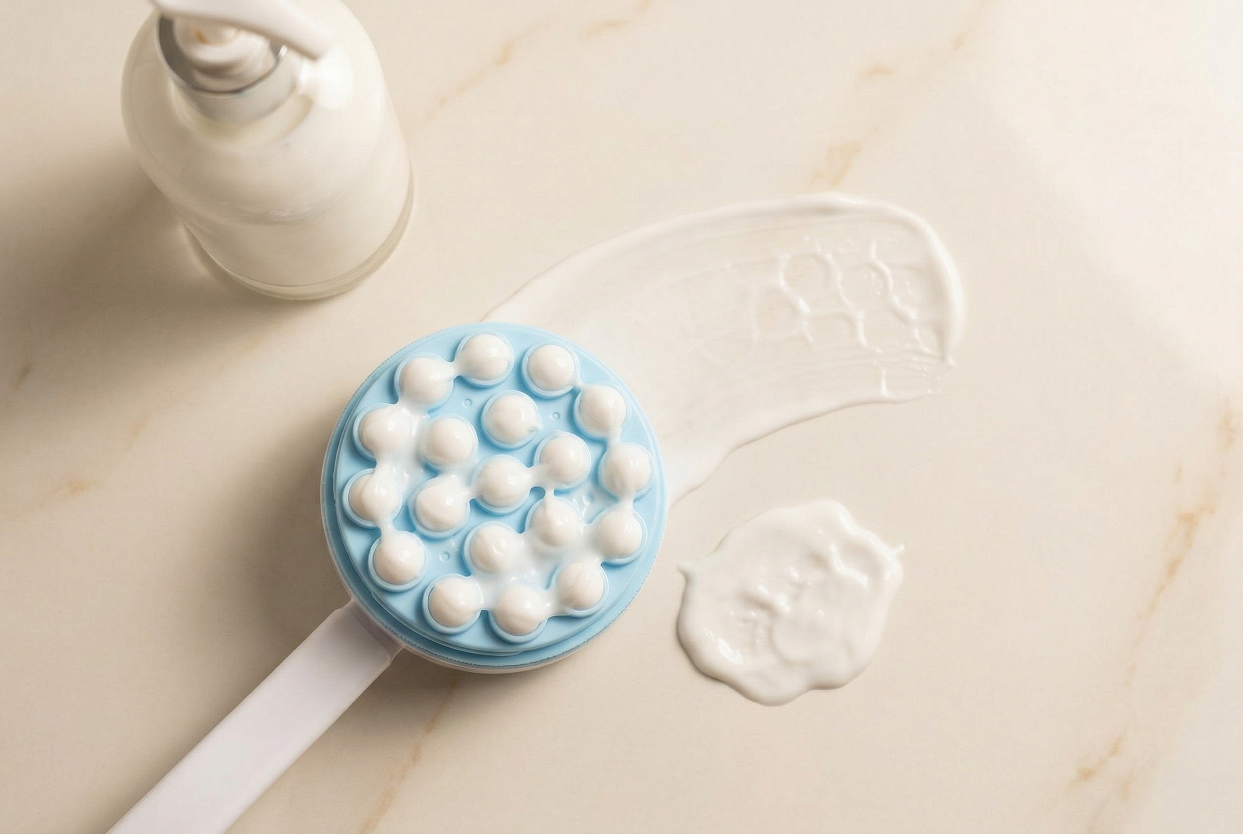 Applicator loaded with lotion showing even distribution across rollers